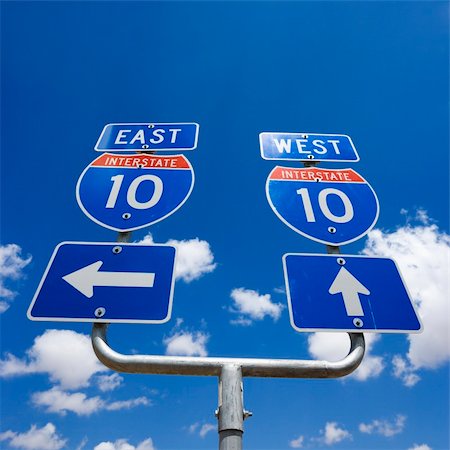 simsearch:600-03696739,k - Highway interstate 10 sign with arrows pointing east and west. Stock Photo - Budget Royalty-Free & Subscription, Code: 400-03935716