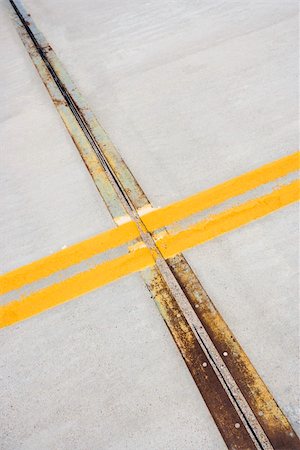Detail of solid double yellow line in road  crossing metal strips in cement. Stock Photo - Budget Royalty-Free & Subscription, Code: 400-03935719