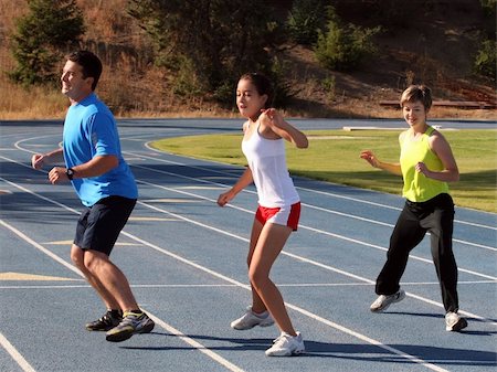 simsearch:400-04535435,k - Mother, father and daughter exercising on a blue racetrack Stock Photo - Budget Royalty-Free & Subscription, Code: 400-03937507