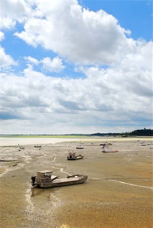 Fishing boats on the ocean floor at low tide in Cancale (Brittany, France). Stock Photo - Budget Royalty-Free & Subscription, Code: 400-03937741