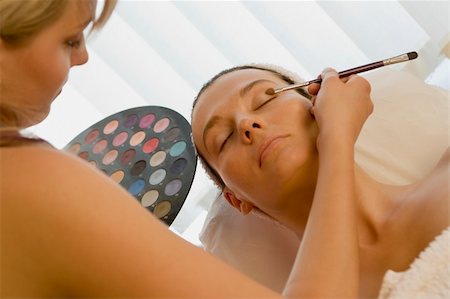 simsearch:400-03950910,k - An attractive dark haired young woman having make up applied by a beautician Photographie de stock - Aubaine LD & Abonnement, Code: 400-03937945