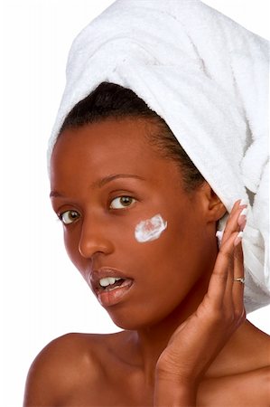 simsearch:400-03950910,k - African-American girl applying facial skincare product (isolated) Photographie de stock - Aubaine LD & Abonnement, Code: 400-03938347