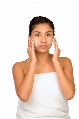 simsearch:400-03950910,k - Hispanic girl applying facial skincare product Photographie de stock - Aubaine LD & Abonnement, Code: 400-03939307