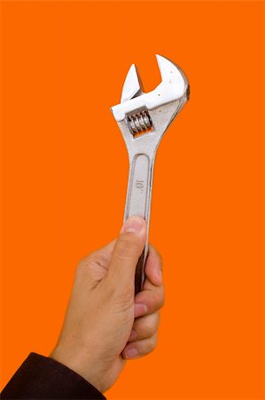 simsearch:400-03947919,k - a hand holding a Wrench tool with a color background Stock Photo - Budget Royalty-Free & Subscription, Code: 400-03939568
