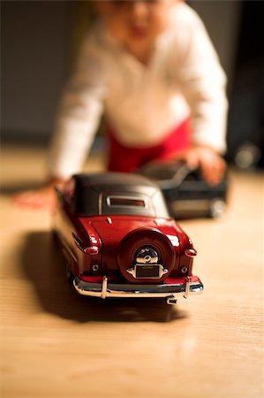 little boy playing indoor with model cars Stock Photo - Budget Royalty-Free & Subscription, Code: 400-03939594