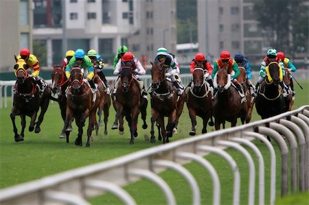 The Horse Racing at Hong Kong Jockey Club. (got some noise due to high ISO and slight blurry for motion effect) Stock Photo - Budget Royalty-Free & Subscription, Code: 400-03939853