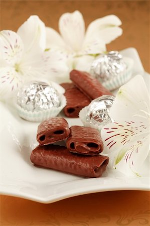 simsearch:614-06537664,k - Sweet chocolate rolls on the plate decoraed with flowers Stock Photo - Budget Royalty-Free & Subscription, Code: 400-03930790