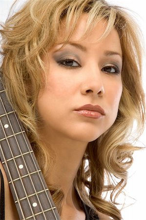 simsearch:400-04652753,k - Young blonde Girl posing with guitar neck Stock Photo - Budget Royalty-Free & Subscription, Code: 400-03930850