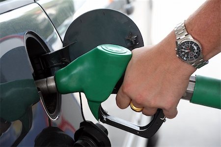 simsearch:6105-05395912,k - A service station gas nozzle in the fuel filling hole of a car. focus on the handle Stock Photo - Budget Royalty-Free & Subscription, Code: 400-03931049