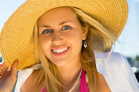 simsearch:400-06422339,k - Portrait of a gorgeous young blond haired blue eyed young woman wearing a sun hat and illuminated by glorious golden evening sunshine Foto de stock - Super Valor sin royalties y Suscripción, Código: 400-03931629