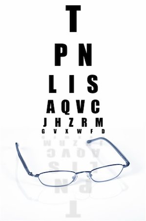 simsearch:400-07774329,k - Glasses with reflection and test vision chart over white background Stock Photo - Budget Royalty-Free & Subscription, Code: 400-03932499