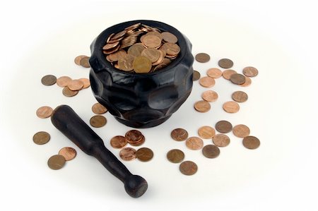 simsearch:400-07218287,k - Grinding for Pennies - Wood mortar and pestle containing pennies bills on a white background. Stock Photo - Budget Royalty-Free & Subscription, Code: 400-03932750