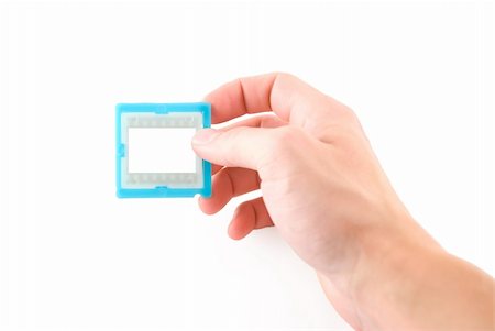 simsearch:400-03909049,k - Slide frame in hand, isolated white Photographie de stock - Aubaine LD & Abonnement, Code: 400-03933731