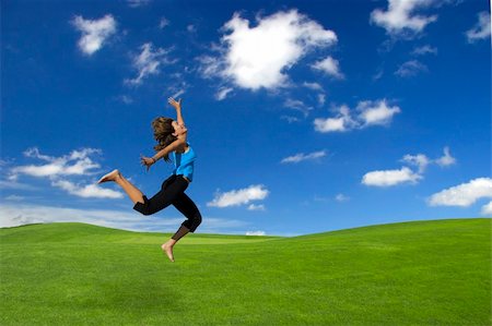 simsearch:400-03934248,k - Beautiful athletic woman jumping on a green field Stock Photo - Budget Royalty-Free & Subscription, Code: 400-03933741