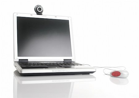 Laptop with a mouse and a webcam over a table with reflection Stock Photo - Budget Royalty-Free & Subscription, Code: 400-03933742
