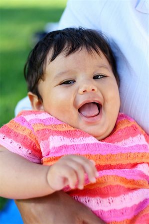 simsearch:400-07509444,k - Closeup of a very cute baby or toddler in bright pink clothings laughing. Stock Photo - Budget Royalty-Free & Subscription, Code: 400-03933974
