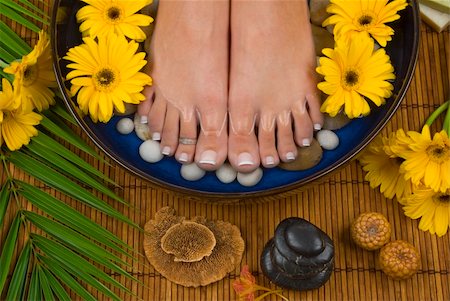 Spa treatment with aromatic gerbera daisies, healing stones, olive oil soaps and mineral water Stock Photo - Budget Royalty-Free & Subscription, Code: 400-03944395