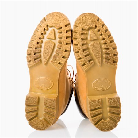 simsearch:700-05973266,k - Pair of tan construction boots with sole facing viewer. Photographie de stock - Aubaine LD & Abonnement, Code: 400-03944770