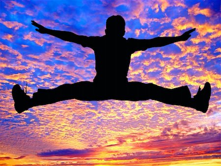 Boy jumping high in the air against the sunset Stock Photo - Budget Royalty-Free & Subscription, Code: 400-03944983