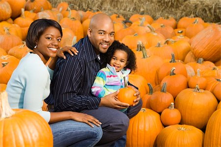 farmers market family - Parents and daughter picking out pumpkin and smiling at outdoor market. Stock Photo - Budget Royalty-Free & Subscription, Code: 400-03949364