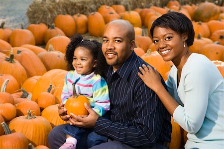 farmers market family - Parents and daughter picking out pumpkin and smiling at outdoor market. Stock Photo - Budget Royalty-Free & Subscription, Code: 400-03949366