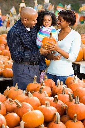 farmers market family - Parents and daughter picking out pumpkin and smiling at outdoor market. Stock Photo - Budget Royalty-Free & Subscription, Code: 400-03949370