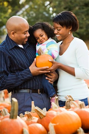 farmers market family - Parents and daughter picking out pumpkin and smiling at outdoor market. Stock Photo - Budget Royalty-Free & Subscription, Code: 400-03949372