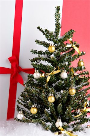 simsearch:632-06118429,k - Christmas tree with a wrapped present Stock Photo - Budget Royalty-Free & Subscription, Code: 400-03949605