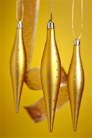 simsearch:614-02241057,k - Christmas ornaments hanging over yellow background Stock Photo - Budget Royalty-Free & Subscription, Code: 400-03949617