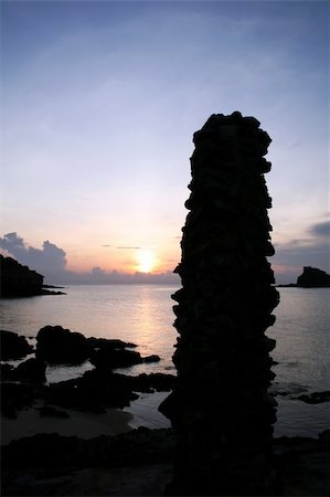 simsearch:400-05745636,k - Seaside sunrise with pile of stones sillhoute Stock Photo - Budget Royalty-Free & Subscription, Code: 400-03940378