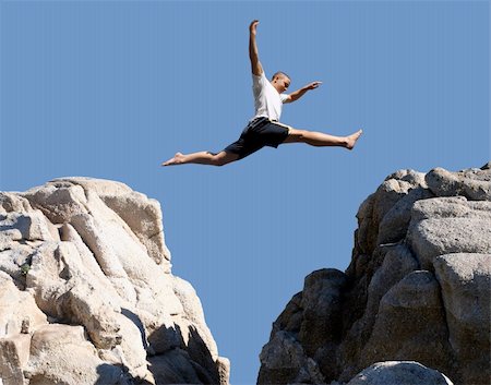 boy jumping over the mountains Stock Photo - Budget Royalty-Free & Subscription, Code: 400-03940446