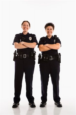 female police officer happy - Portrait of two mid adult Caucasian policewomen standing with arms crossed looking at viewer smiling. Photographie de stock - Aubaine LD & Abonnement, Code: 400-03940749