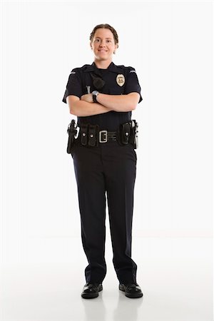 female police officer happy - Portrait of mid adult Caucasian female law enforcement officer standing with arms crossed looking at viewer smiling. Photographie de stock - Aubaine LD & Abonnement, Code: 400-03940743