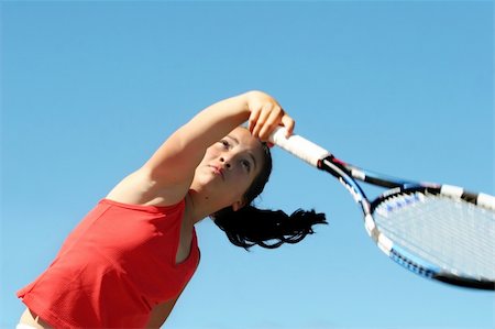 simsearch:640-06050635,k - Girl playing tennis against blue sky Stock Photo - Budget Royalty-Free & Subscription, Code: 400-03940776