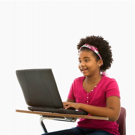 simsearch:400-05012508,k - African American girl sitting in school desk typing on laptop computer. Foto de stock - Super Valor sin royalties y Suscripción, Código: 400-03940964