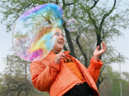 simsearch:632-05604245,k - Girl playing with bubbles in a park Stock Photo - Budget Royalty-Free & Subscription, Code: 400-03941869