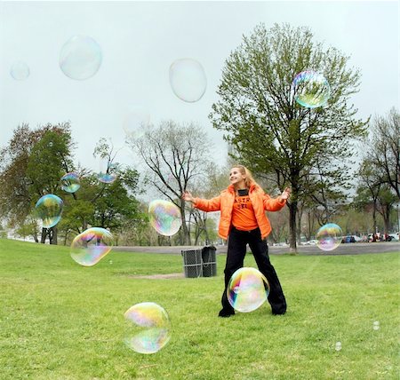 simsearch:632-05604245,k - Girl playing with bubbles in a park Stock Photo - Budget Royalty-Free & Subscription, Code: 400-03941861