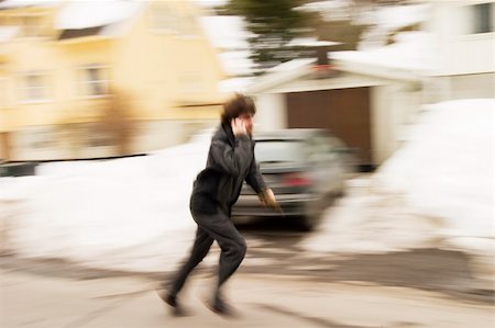 people running scared - A motion blur abstract of a person walking in a hurry talking on a cell phone Stock Photo - Budget Royalty-Free & Subscription, Code: 400-03942220