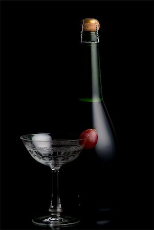 simsearch:400-07166551,k - Champagne Botlte with a glass on a black background Stock Photo - Budget Royalty-Free & Subscription, Code: 400-03942824