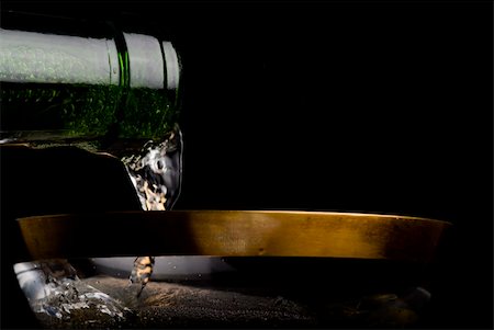 simsearch:400-07166551,k - Pouring champagne in a beautiful gold edged glass. black background. Stock Photo - Budget Royalty-Free & Subscription, Code: 400-03942829