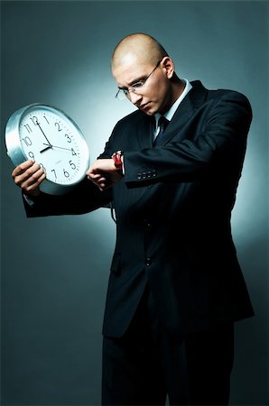 simsearch:400-03954954,k - A Young businessman checking his watch. Time is money Stock Photo - Budget Royalty-Free & Subscription, Code: 400-03954997