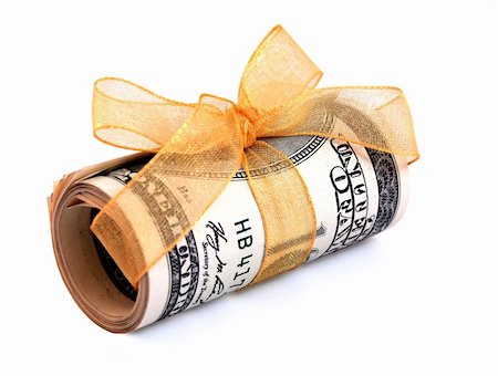 simsearch:400-04011910,k - Money roll wrapped in a golden ribbon with a bow on top Stock Photo - Budget Royalty-Free & Subscription, Code: 400-03955810