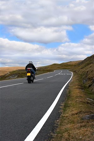 simsearch:400-04436530,k - Lone motorbike rider on an uphill mountain road in the Brecon Beacons National Park, Wales, United Kingdom. Stock Photo - Budget Royalty-Free & Subscription, Code: 400-03957906