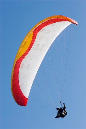 Colorful paraglider in front of a blue sky Stock Photo - Budget Royalty-Free & Subscription, Code: 400-03964058