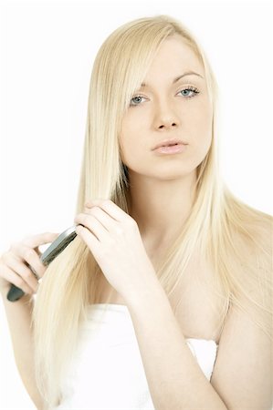 Portrait of Fresh and Beautiful young blond woman brushing her hair Photographie de stock - Aubaine LD & Abonnement, Code: 400-03964899