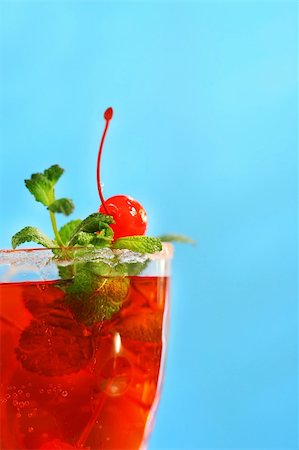 simsearch:400-03965729,k - Red tropical drink with mint and cherries against a blue sky Stock Photo - Budget Royalty-Free & Subscription, Code: 400-03965748