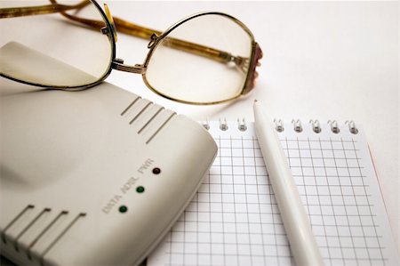 simsearch:6109-08395080,k - modem, notebook, pen and glasses on a light background Stock Photo - Budget Royalty-Free & Subscription, Code: 400-03965758