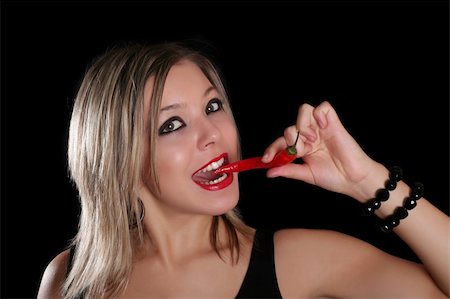 simsearch:614-03191133,k - Beautiful girl with red pepper, isolated on black background Stock Photo - Budget Royalty-Free & Subscription, Code: 400-03966788