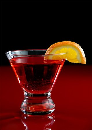 A cosmo martini with an orange slice with a red and black background Stock Photo - Budget Royalty-Free & Subscription, Code: 400-03966911