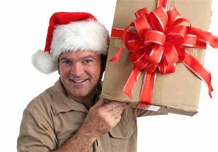 a Christmas delivery man shaking a gift and smiling as he tried to guess what's inside - isolated Stock Photo - Budget Royalty-Free & Subscription, Code: 400-03967059